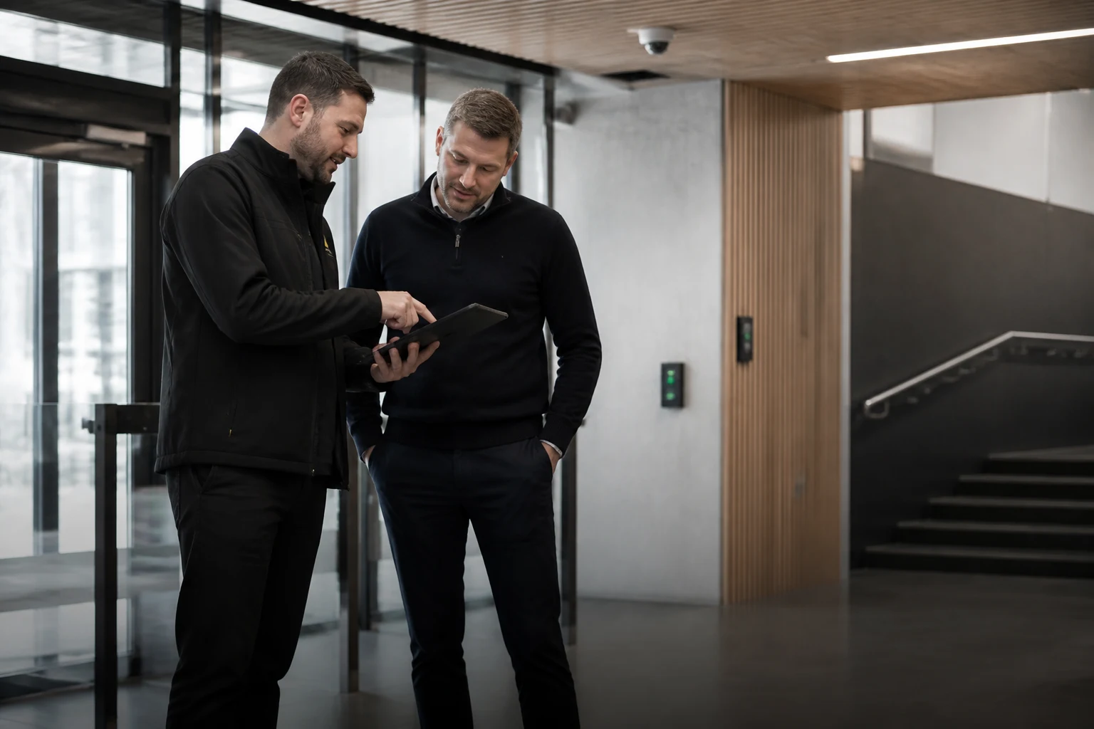 An engineer reviewing a completed fire and security installation with a client