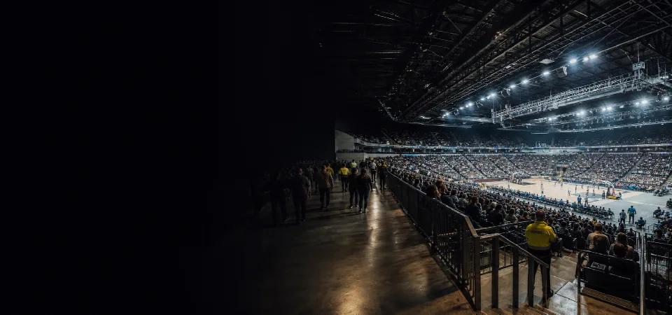Spectators at a stadium sporting event inside a major indoor arena
